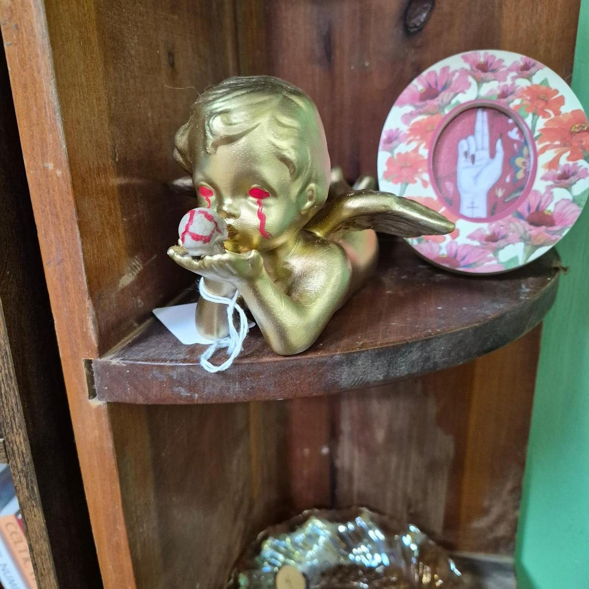 Gold cherub figurine with red