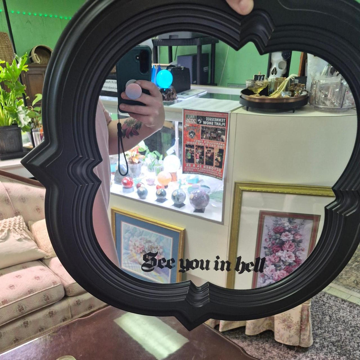 Black ornate mirror with scalloped