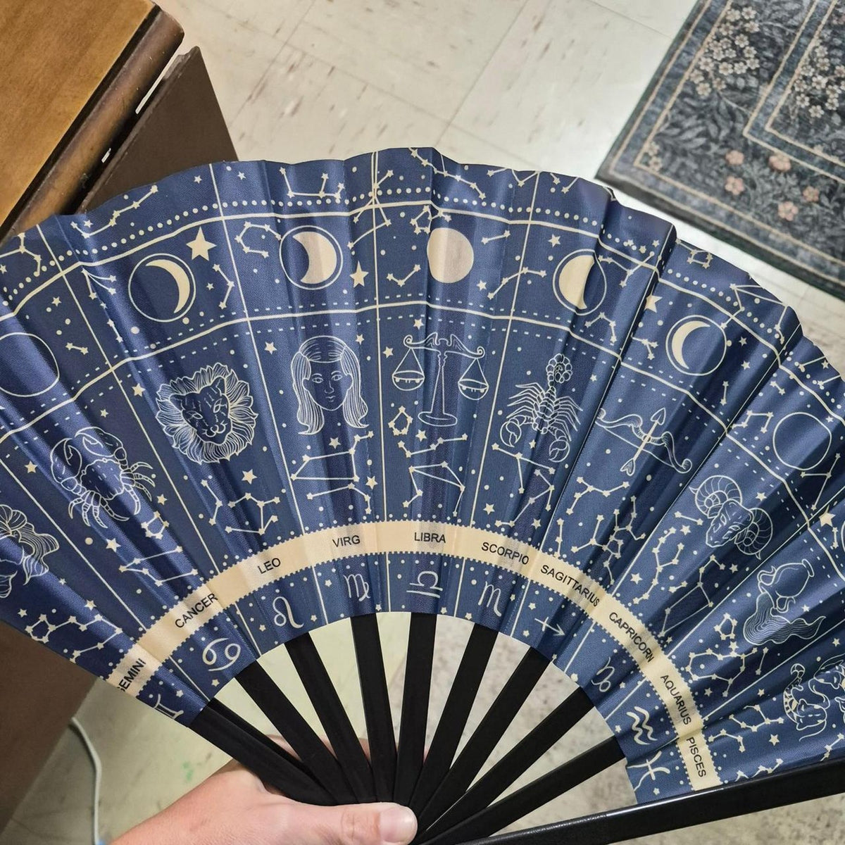 Blue zodiac constellation fan with