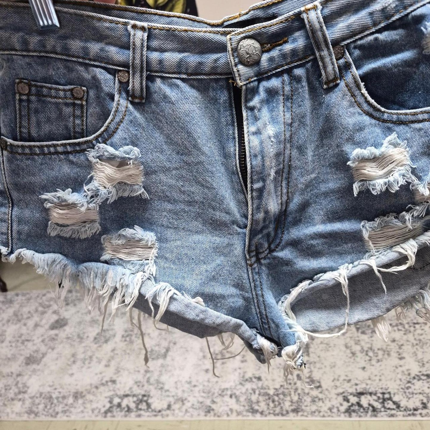 Blue denim shorts with frayed