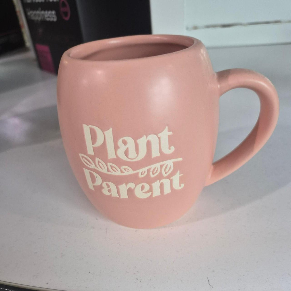 Pink mug with white text